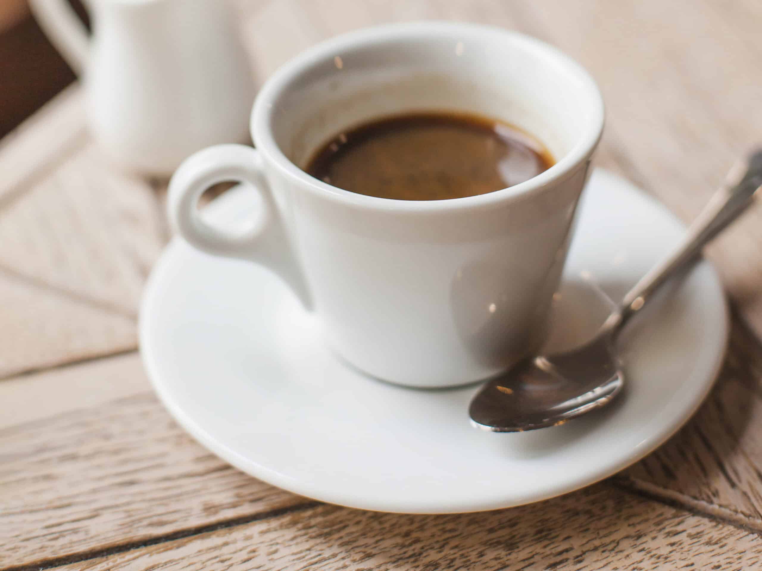 close up coffee cup wooden table caf edited scaled